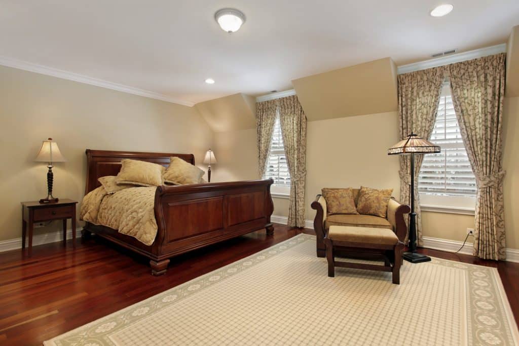 Master bedroom with cherry wood flooring - 101 Inspiring Master Bedroom Remodel Ideas & Pictures - HandyMan.Guide - Master Bedroom