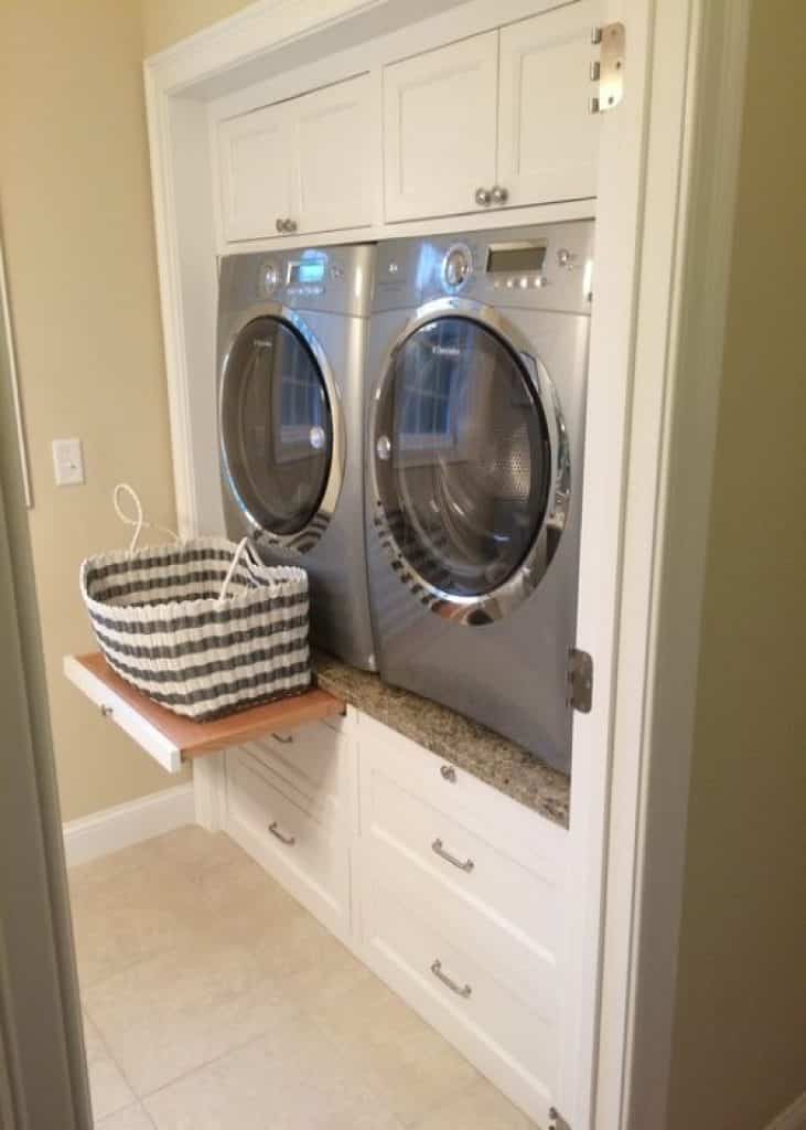 contemporary laundry room with raised washer dryer white cabinets drawer slide - laundry room ideas - HandyMan.Guide -