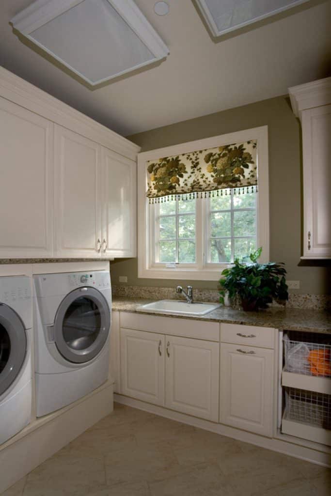 laundry room with raised panel overlay doors in white and built in front loading cabinetwerks by orren pickell - laundry room ideas - HandyMan.Guide -