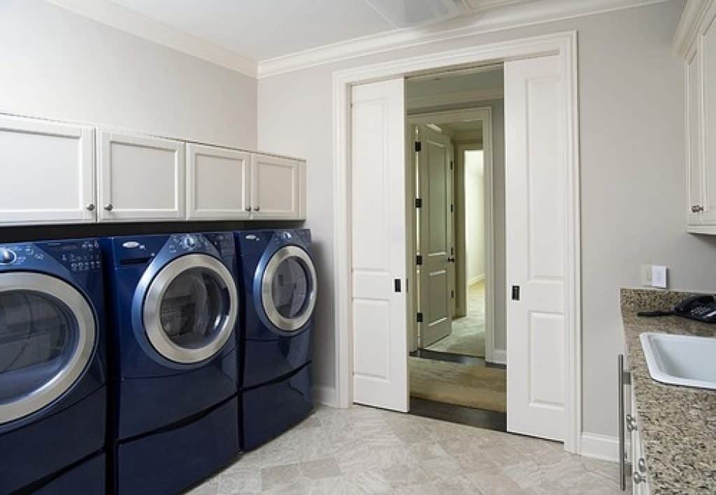 laundry room with two sets of washers and dryers and flat panel cabinetry orren pickell building group - laundry room ideas - HandyMan.Guide -