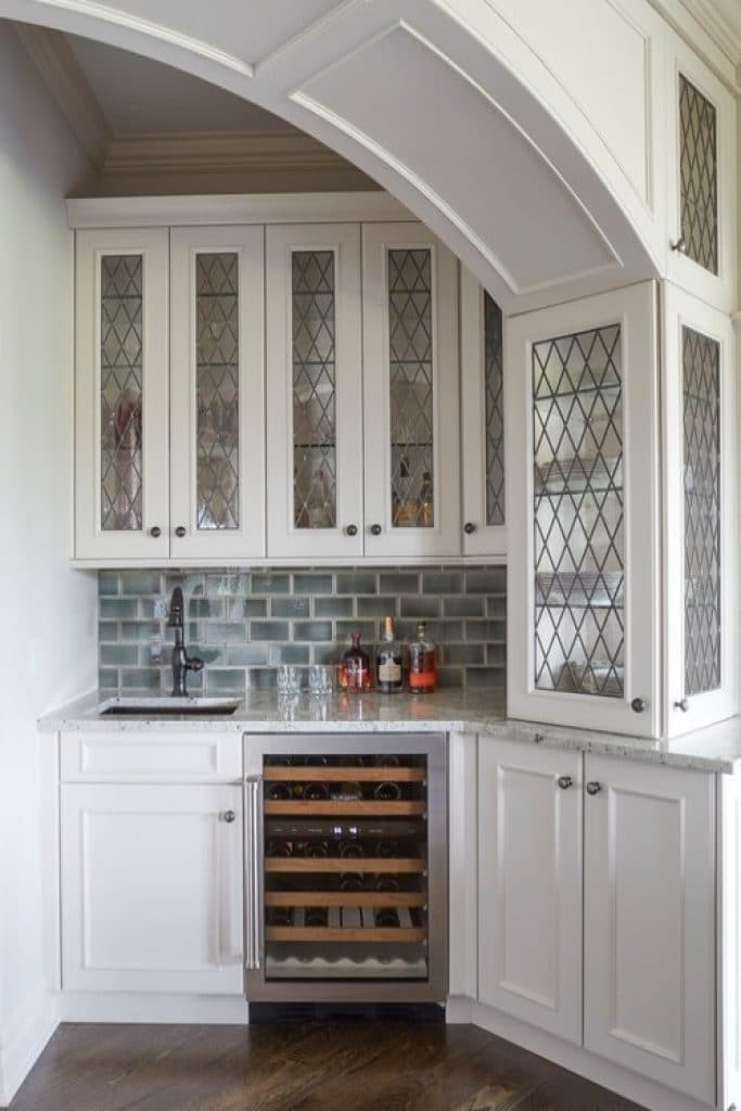 wet bar with arched opening and glass fronted cabinetry orren pickell building group - 152 Wet Bar Ideas for Inspiration to Transform Your Space - HandyMan.Guide - Wet Bar Ideas
