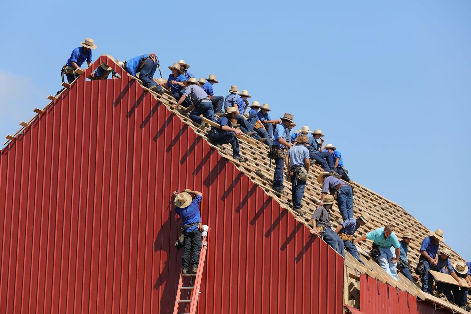 group of construction workers constructing house
